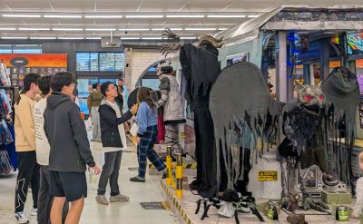 Language and Culture Institute students look at towering animatronic monsters and other Halloween displays inside a Spirit Halloween store
